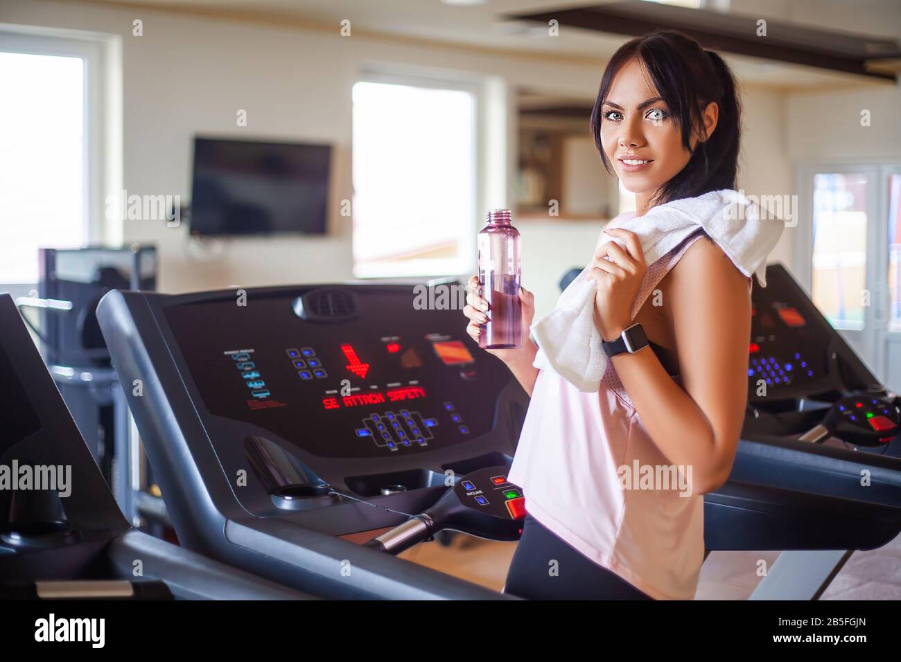 Pretty woman doing physical exercises in gym Stock Photo