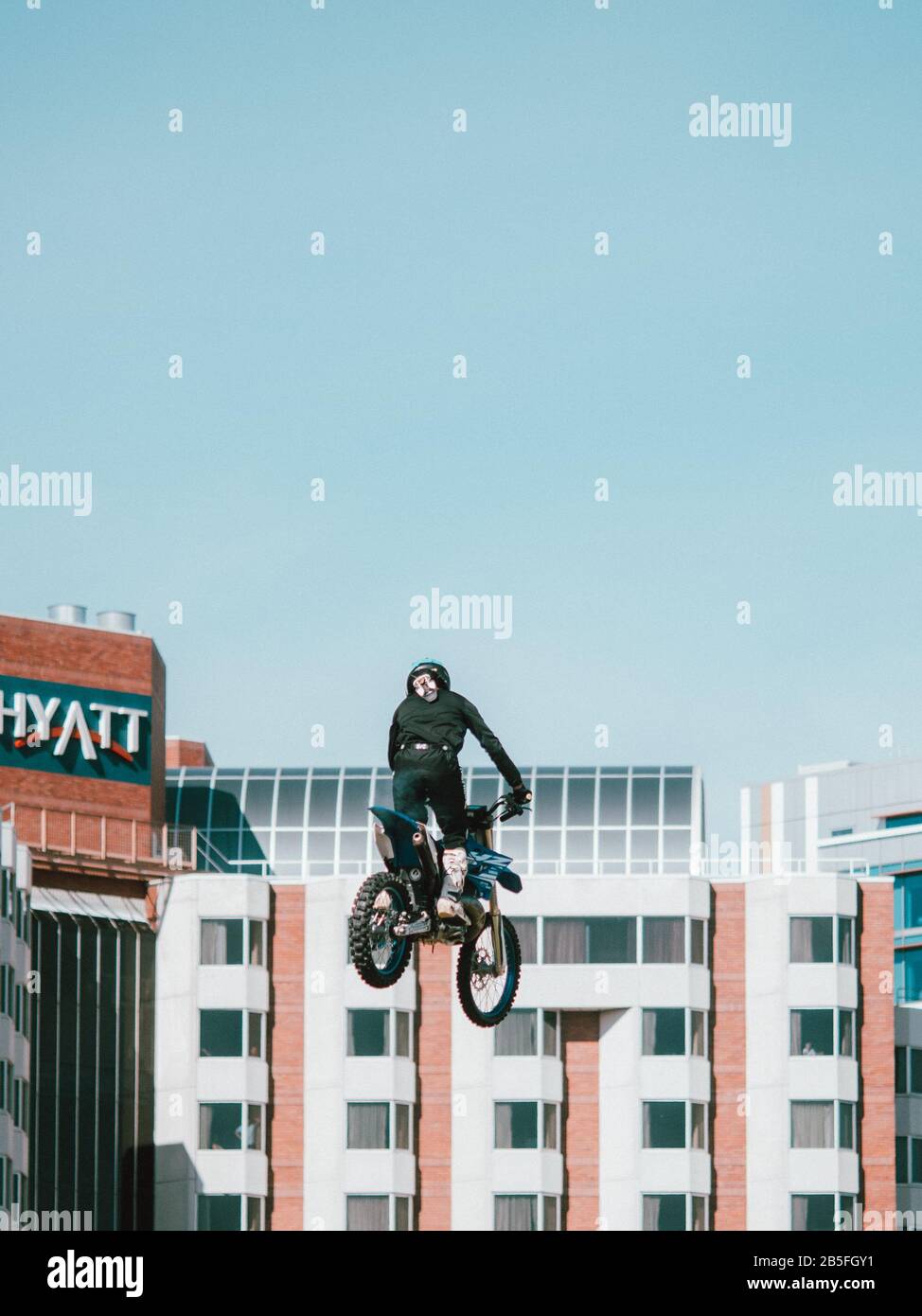 A motorcyclist doing a trick/flip in a city scene in Perth, Australia Stock Photo