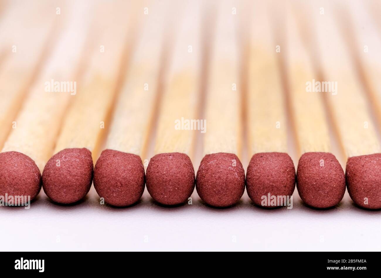 Matchsticks, close up macro of red matchstick heads against white background Stock Photo
