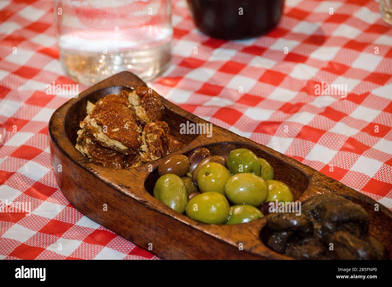 Bowls of Green and black olives served as appetizers Stock Photo