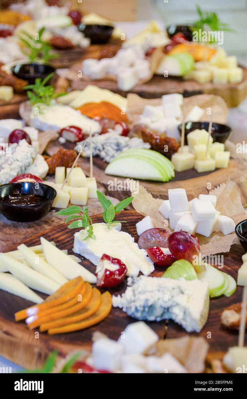 Finger food, snacks and various cheese sandwiches laid out on a table Stock Photo
