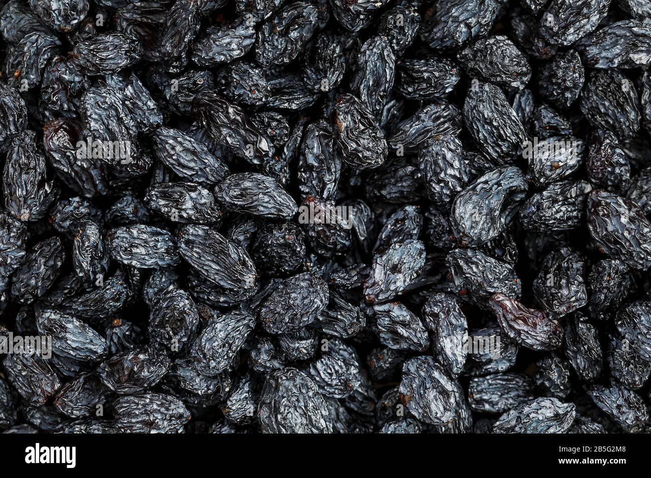 Black Raisin texture, popular dried fruit. Dried grapes. Red seedless