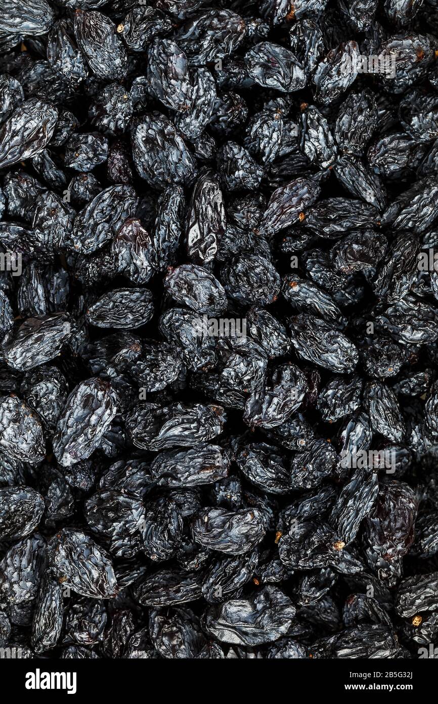 Black Raisin texture, popular dried fruit. Dried grapes. Red seedless