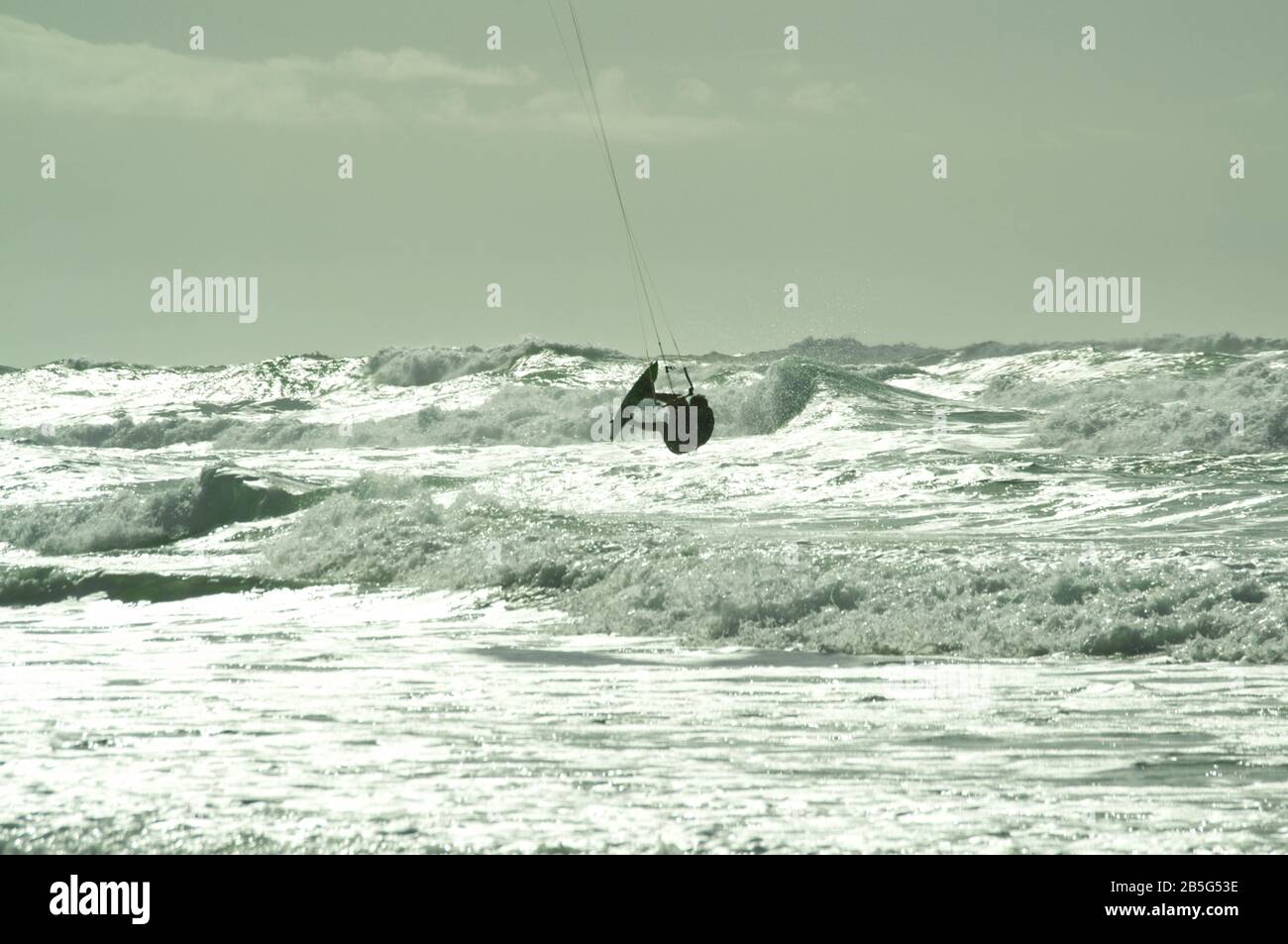Kite surfer summersaulting in rough seas at Lacanau-Océan, France Stock Photo