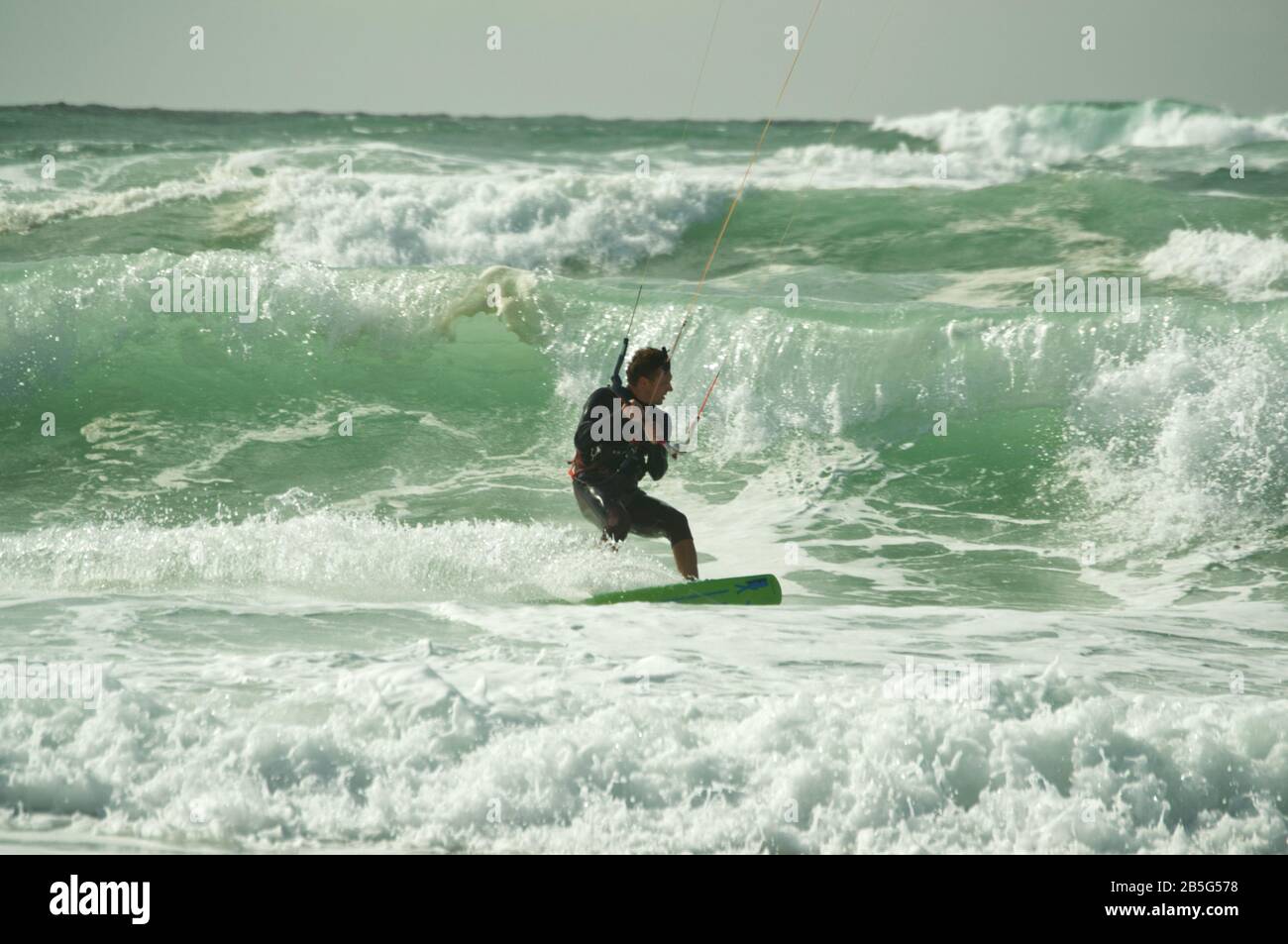 Kite surfer riding though waves and rough seas at Lacanau-Océan, France Stock Photo