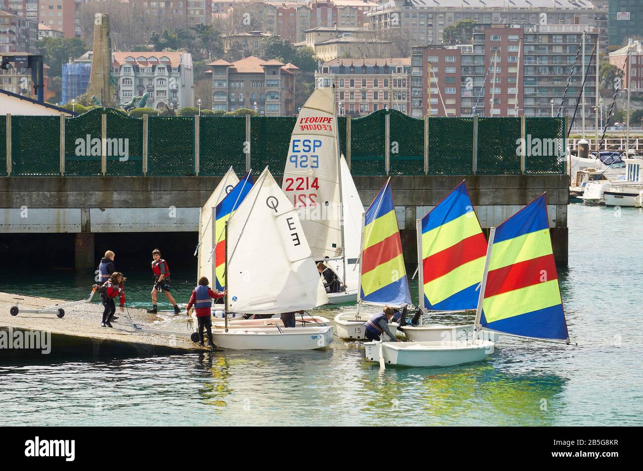 Children preparing optimist sailing boats in a boat ramp for a course at Real Club Marítimo del Abra (Las Arenas, Getxo, Biscay, Basque Country,Spain) Stock Photo