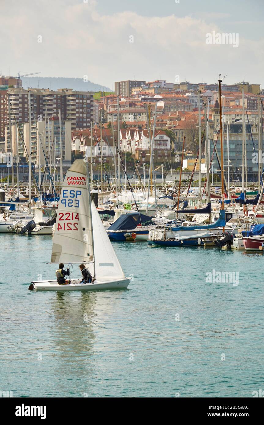 Vaurien sailing boat in the marina of Real Club Marítimo del Abra with Portugalete in the background (Las Arenas, Getxo, Biscay, Basque Country,Spain) Stock Photo