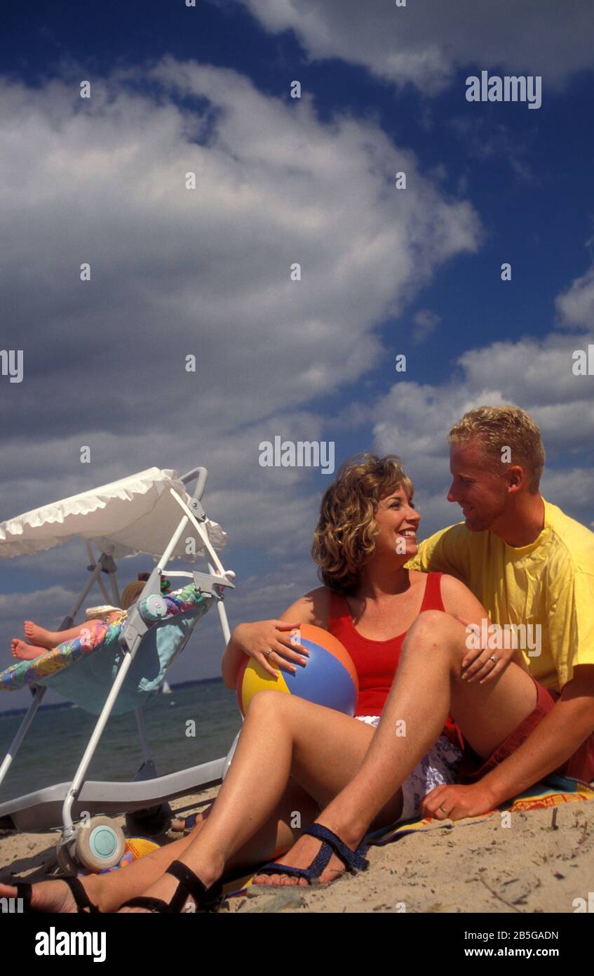 happy couple on beach with their baby Stock Photo