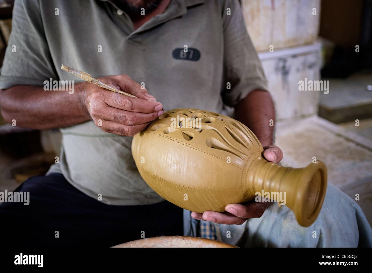 Closeup of local craftsman demonstrates on making traditional clay jar called Labu Sayong or Essence Jar of Sayong at Kuala Kangsar, Perak, Malaysia. Stock Photo