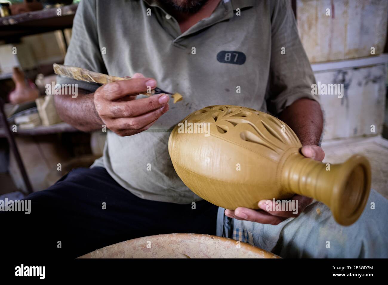 Closeup of local craftsman demonstrates on making traditional clay jar called Labu Sayong or