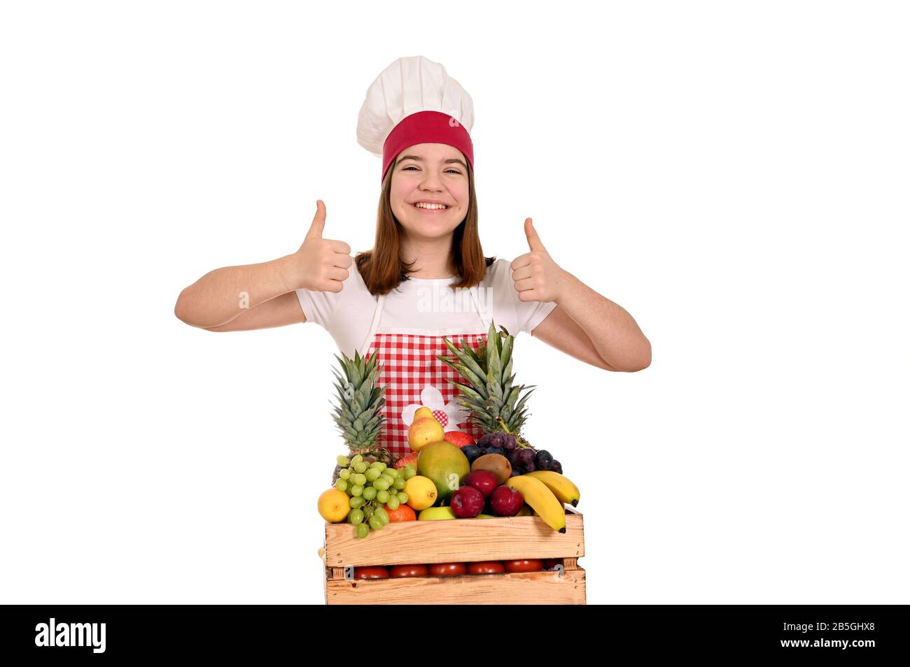female cook with fruit and thumbs up Stock Photo