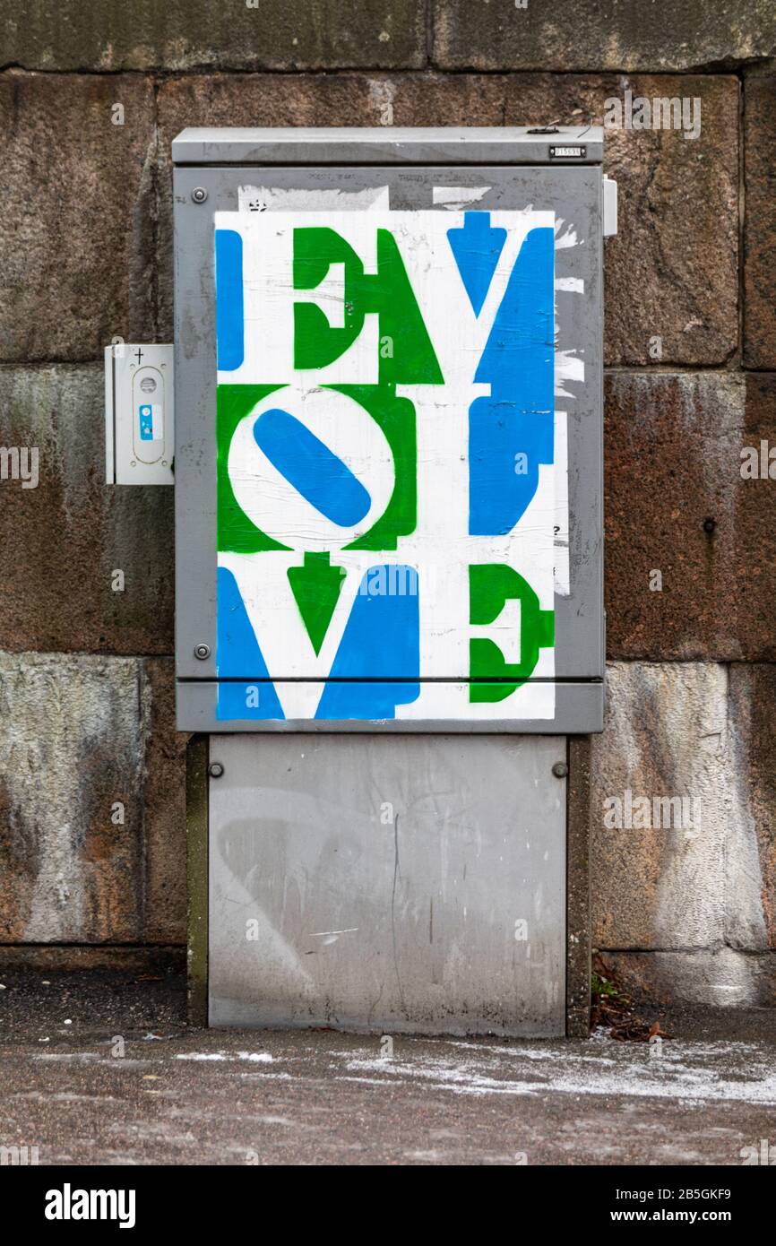 Evolve - a homage to Robert Indiana's pop art classic by Plan B - on electrical enclosure in Helsinki, Finland Stock Photo