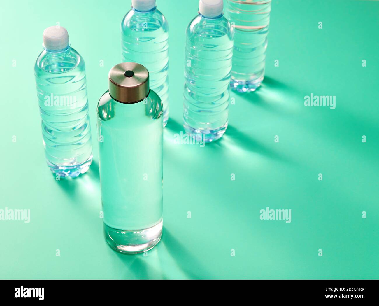 Zero waste concept reusable glass water bottle vs single use plastic