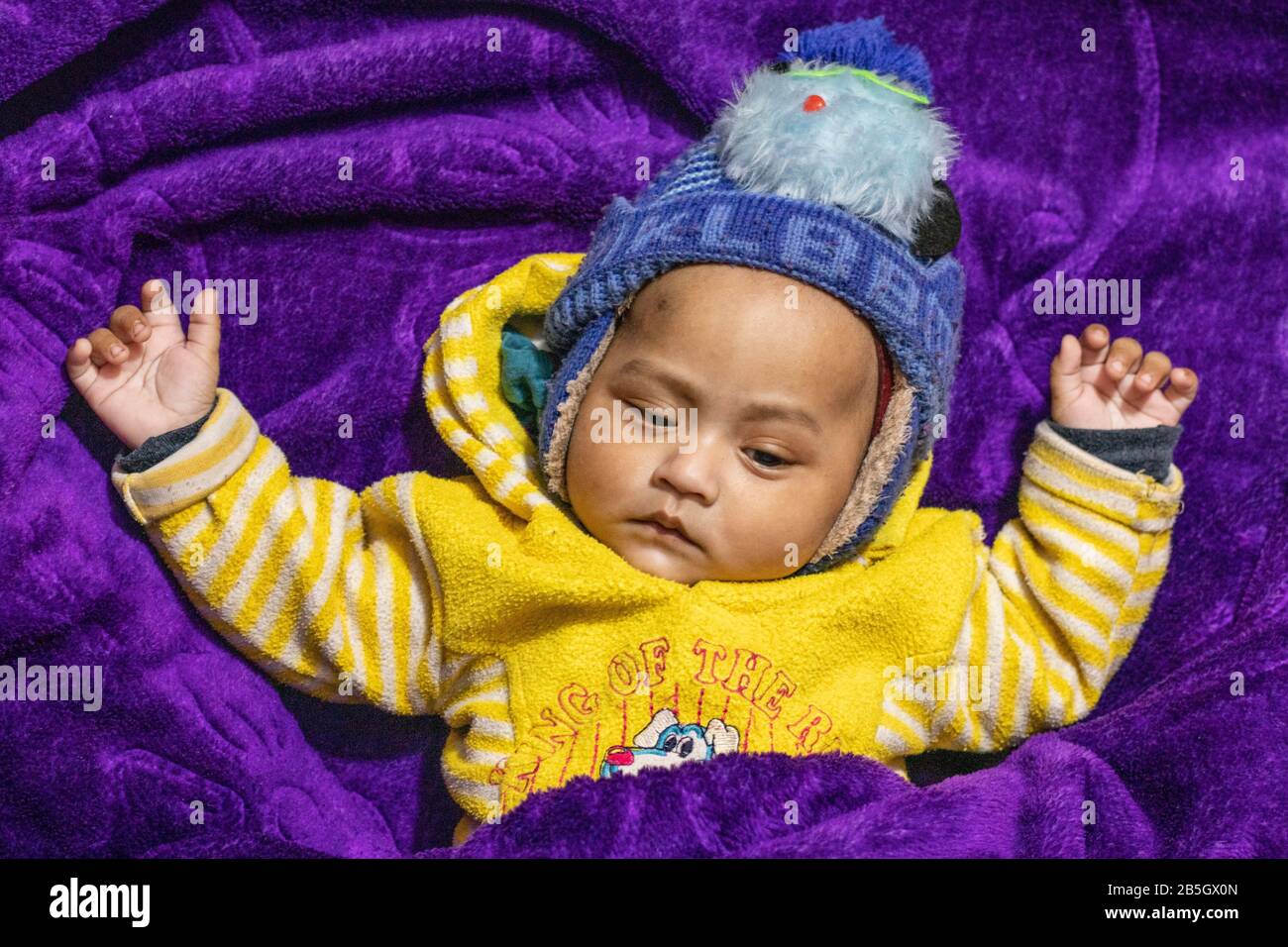 Newborn indian baby close-up on voilet blanket background Stock Photo
