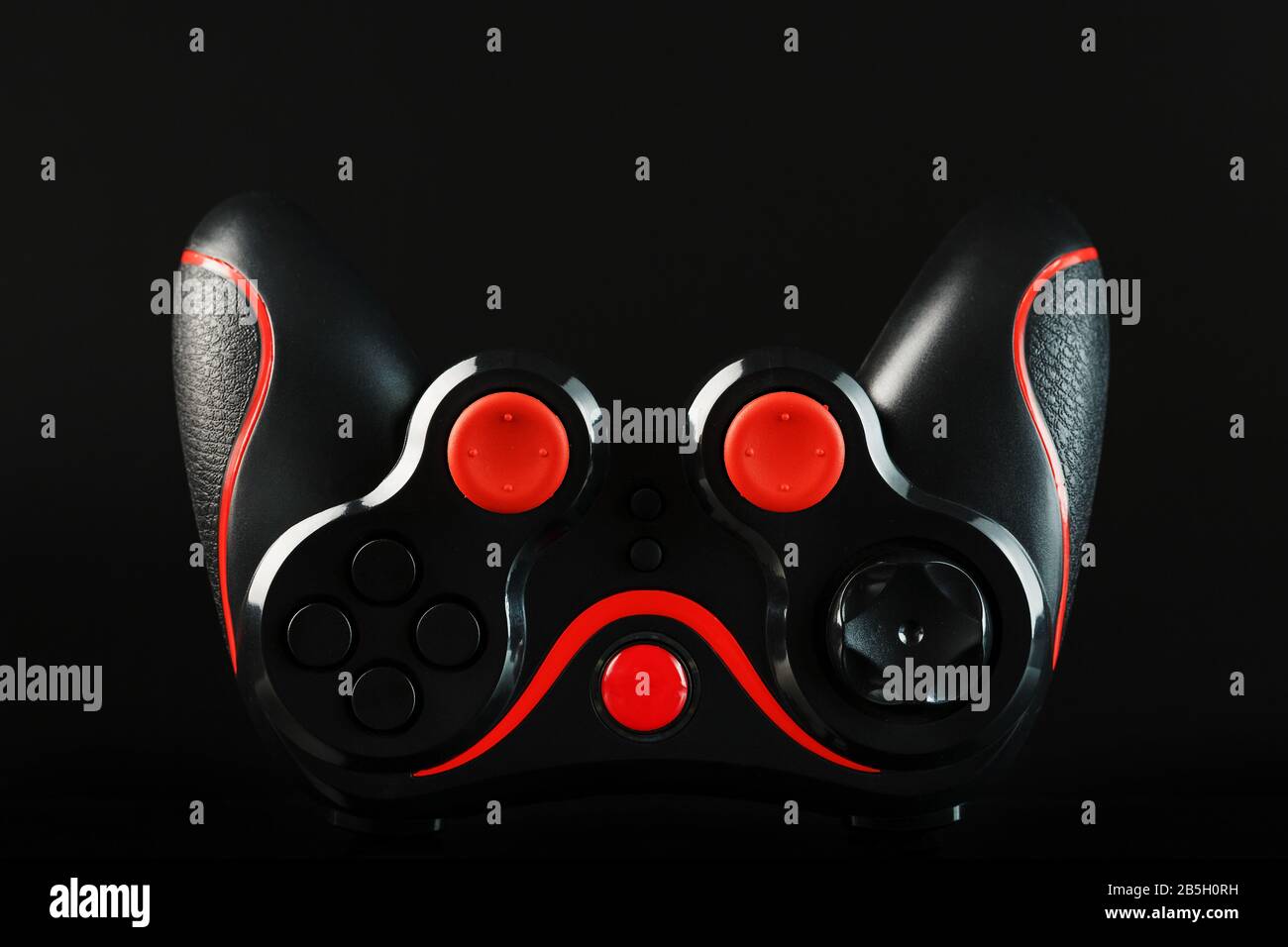 Black game controller gamepad with red buttons on black background upside  down close up. Device to control and control the game. Video games on PC,  co Stock Photo - Alamy