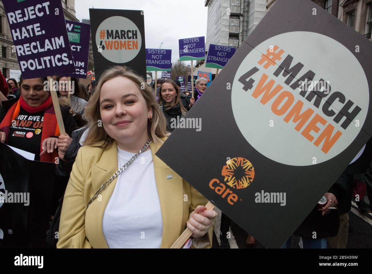 London, UK. 8th Mar 2020. Celebrities, campaigners and politicians joined the March4Women, organised by Care and the Women's Equality Party, to mark International Women's Day. Here in a yellow jacket, Derry Girls actress Nicola Coughlan carried a placard and joined in the chanting. Credit: Anna Watson/Alamy Live News Stock Photo