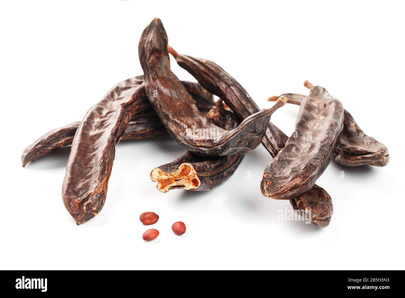 Carob carob fruit and seeds on white background. Isolate. Organic carob
