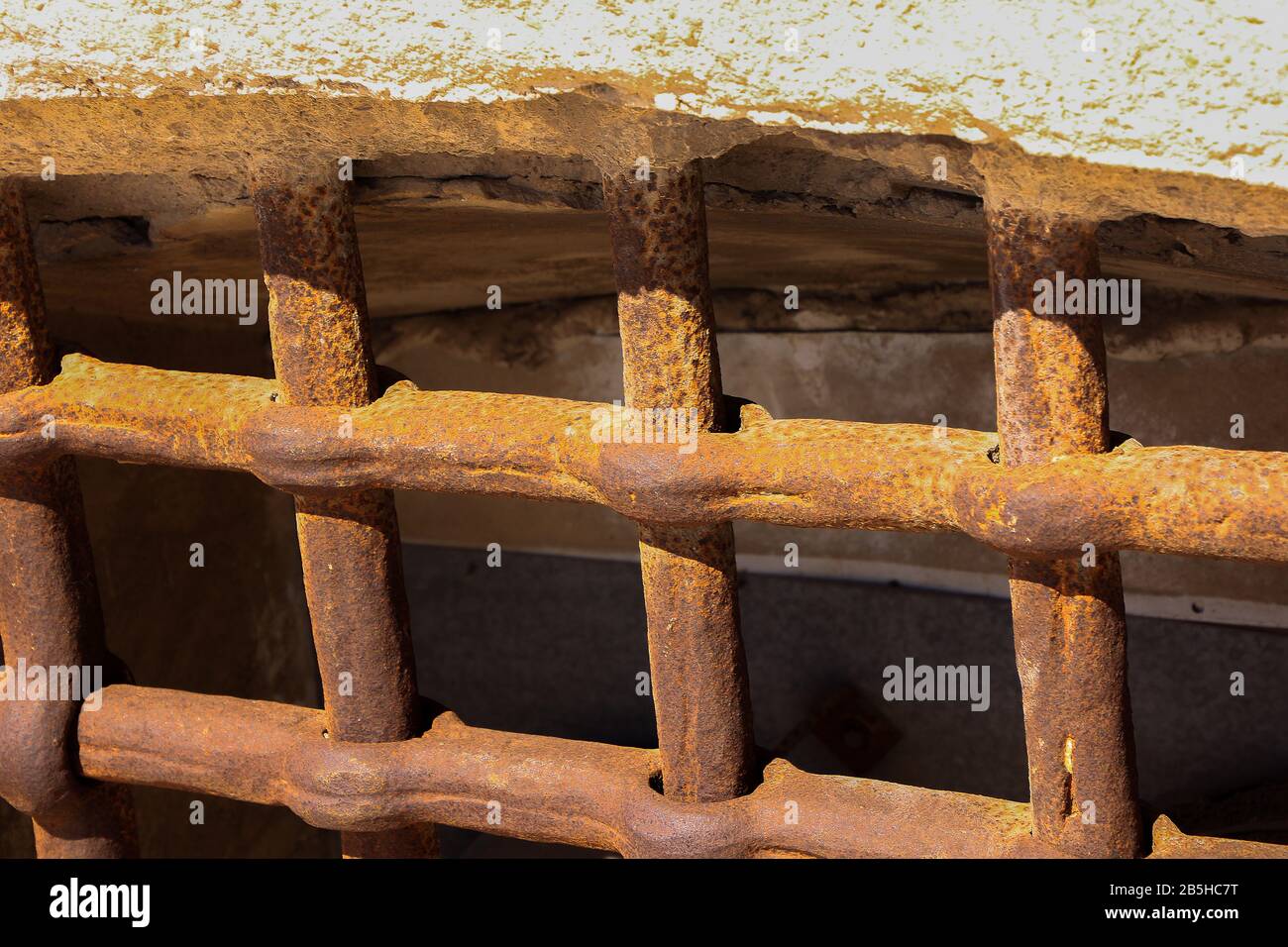 thick bars of rusty iron in a window Stock Photo