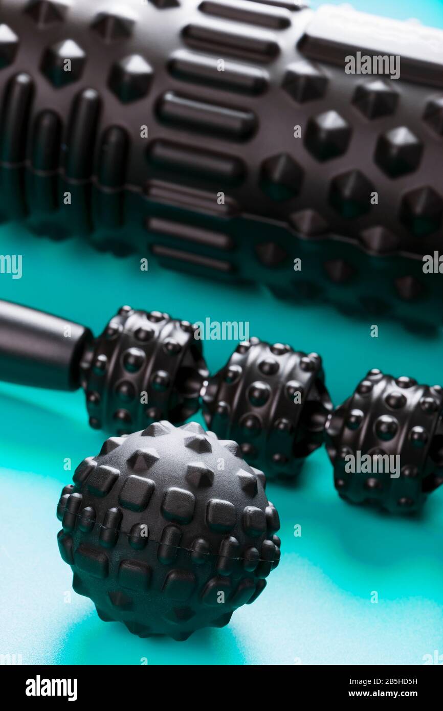 A set of black bumpy foam massage rollers, body rollers, rubber balls