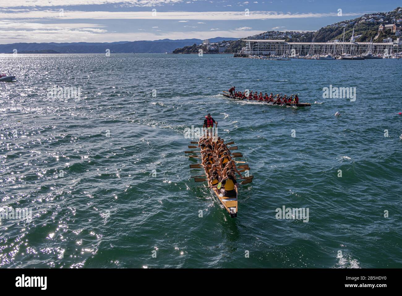 Two dragon boats just after passing finishing line Stock Photo