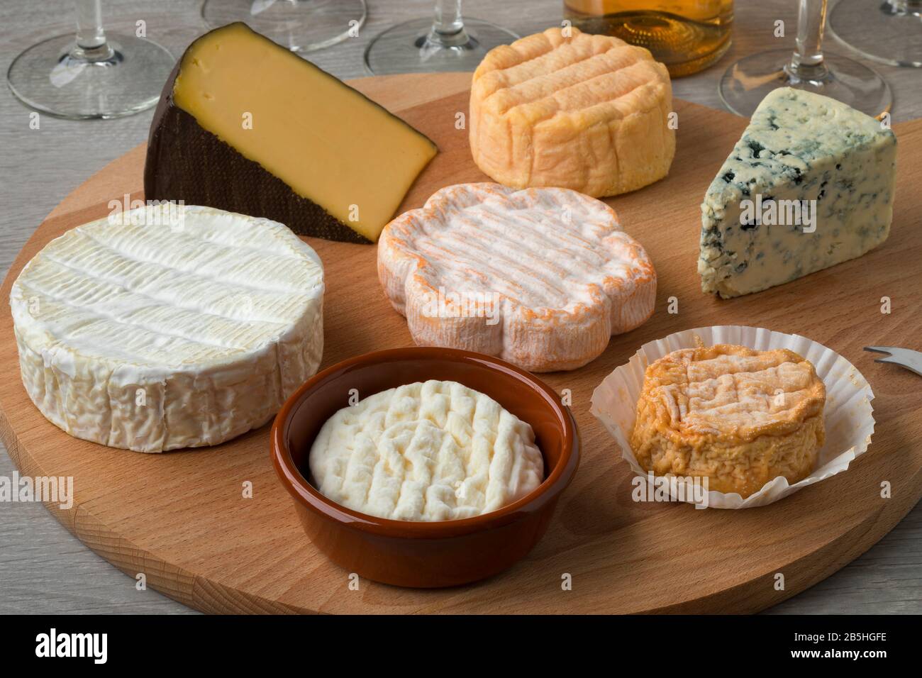 Wooden cheese board with a variety of cheeses for dessert close up Stock Photo