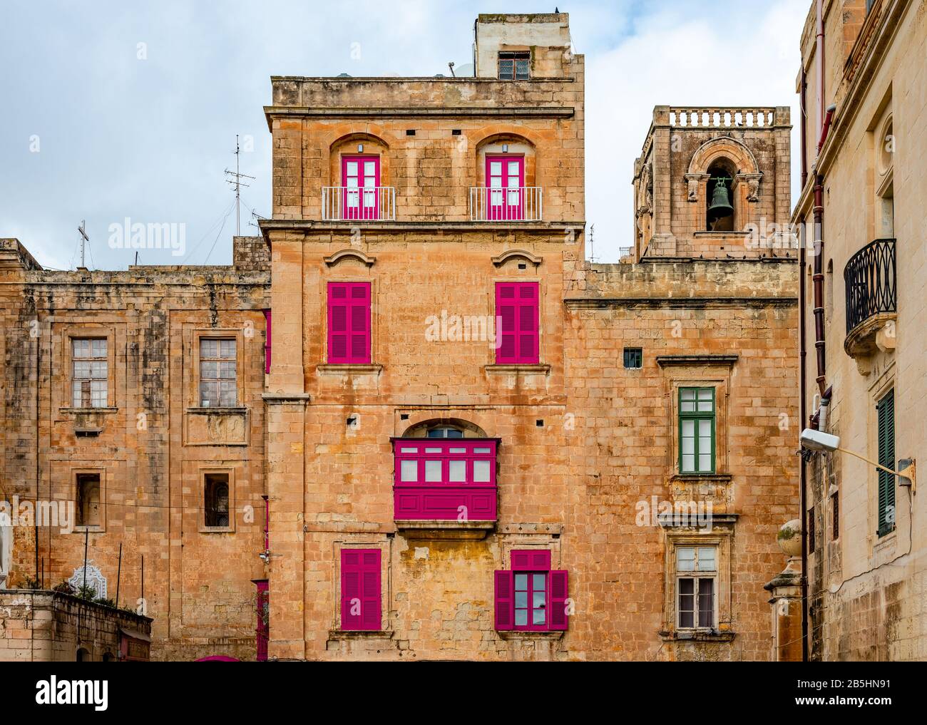 Old houses with colorful wooden balconies in La Valletta, Malta, typical of the traditional Maltese architecture. Stock Photo