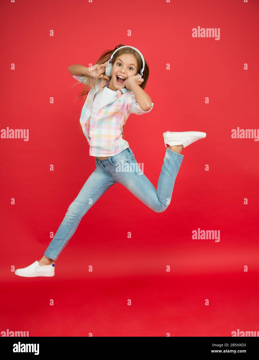 Jumping mid air. Happy small girl dancing. Cute child enjoying happy