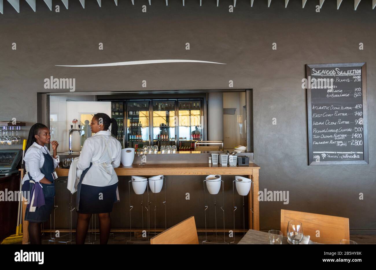Western Cape, South Africa. Dec 2019. Restaurant waitrons at the bar and servery in a South African restaurant. Stock Photo