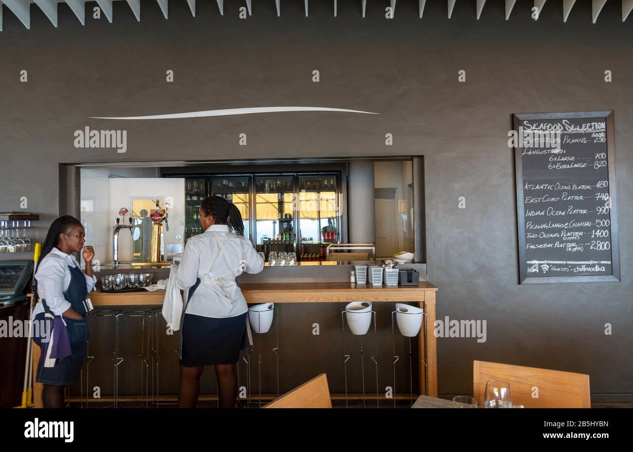 Western Cape, South Africa. Dec 2019. Restaurant waitrons at the bar and servery in a South African restaurant. Stock Photo