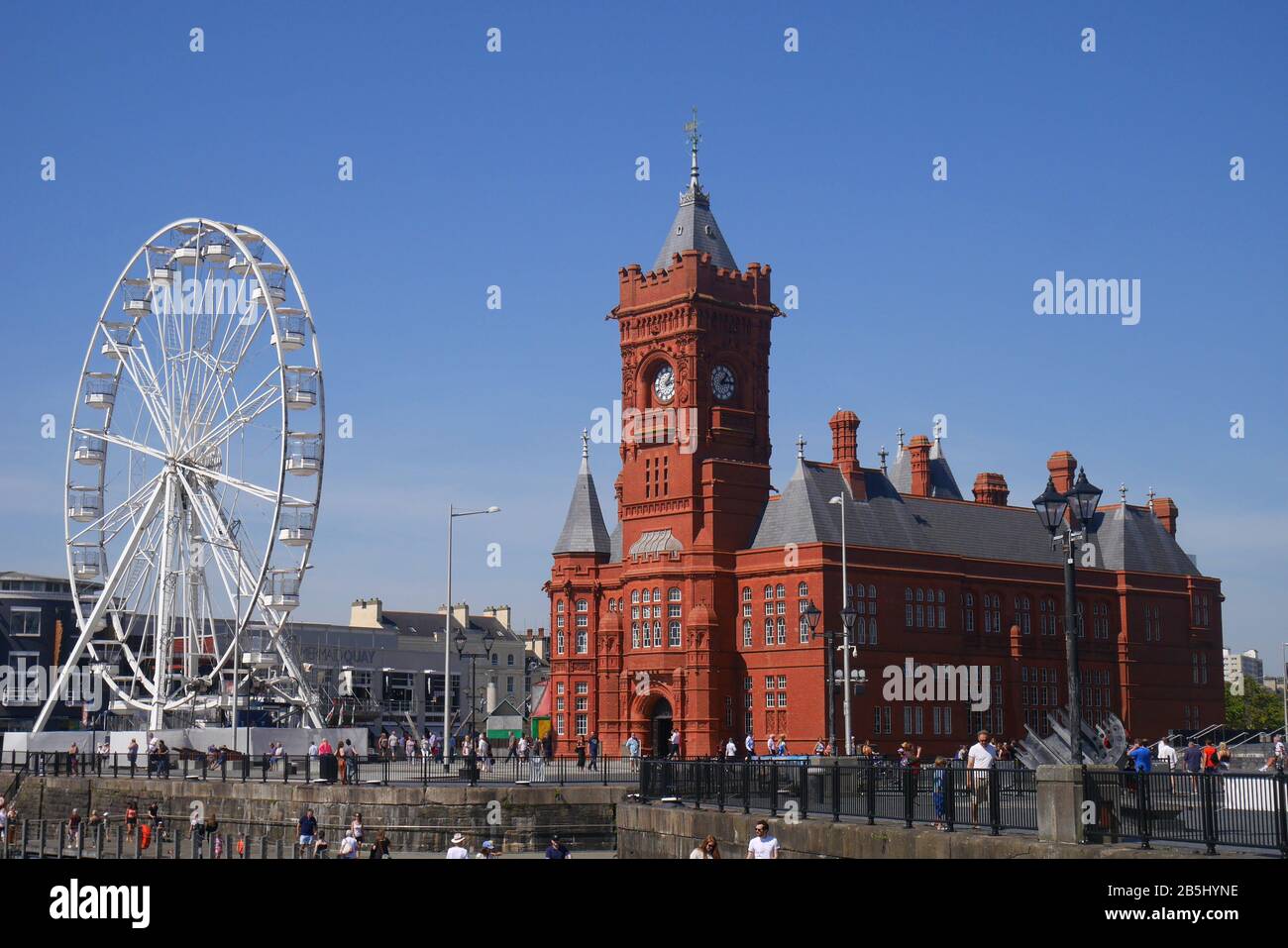 The Grade 1 listed Pierhead building of the National Assembly for Wales, designed by William Frame, and big wheel, Cardiff Bay, Cardiff, Wales, UK Stock Photo