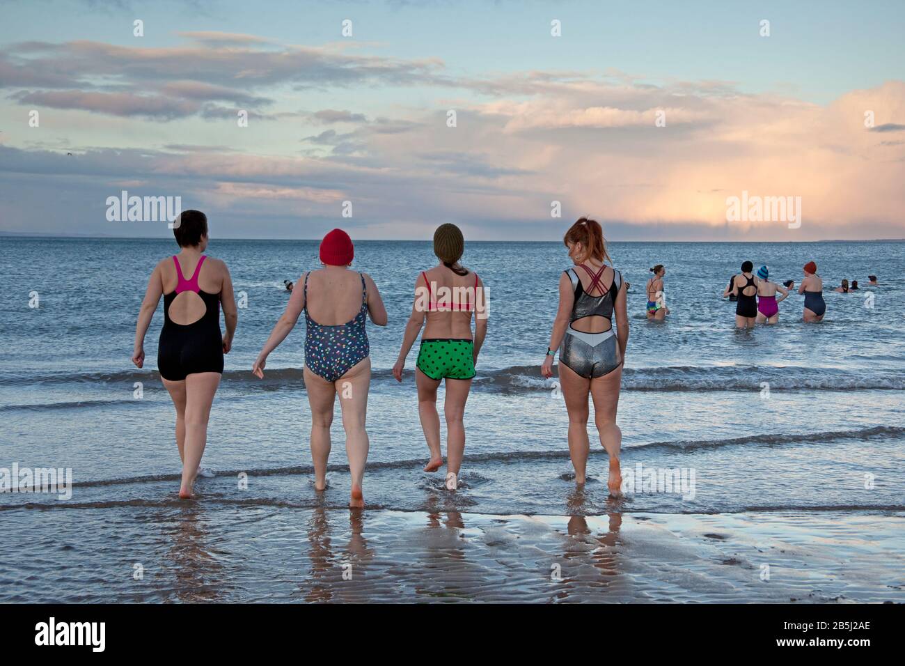 Portobello, Edinburgh, Scotland, UK, 8th Mar 2020. On International Women's Day a celebration of womenhood, by taking a sunset swim organised by WanderWomen. Stock Photo