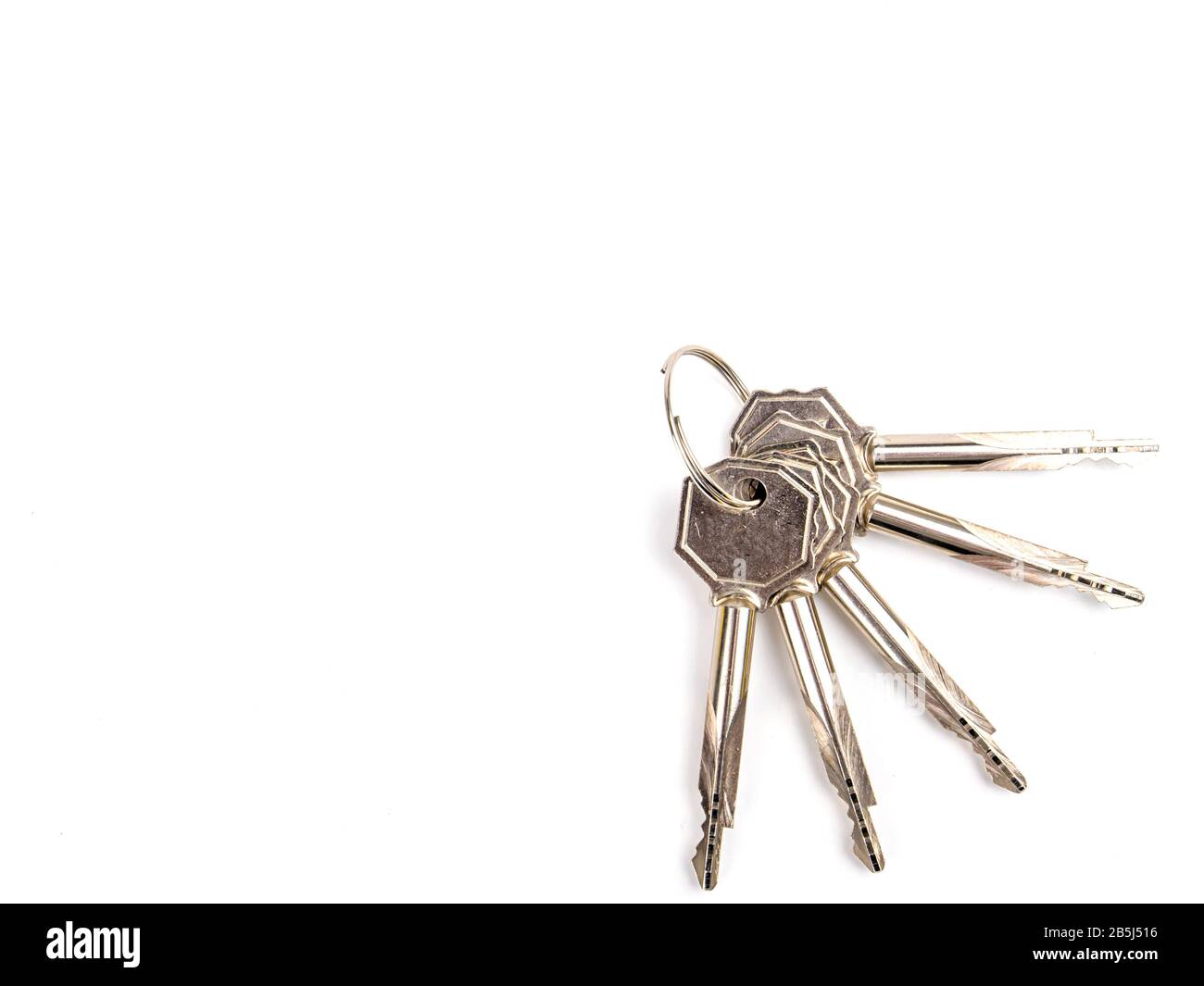 A bunch of keys to a door lock on a white background Stock Photo - Alamy