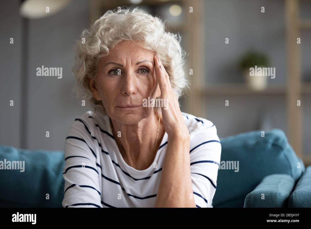 Upset elderly woman feel lonely suffer from depression Stock Photo