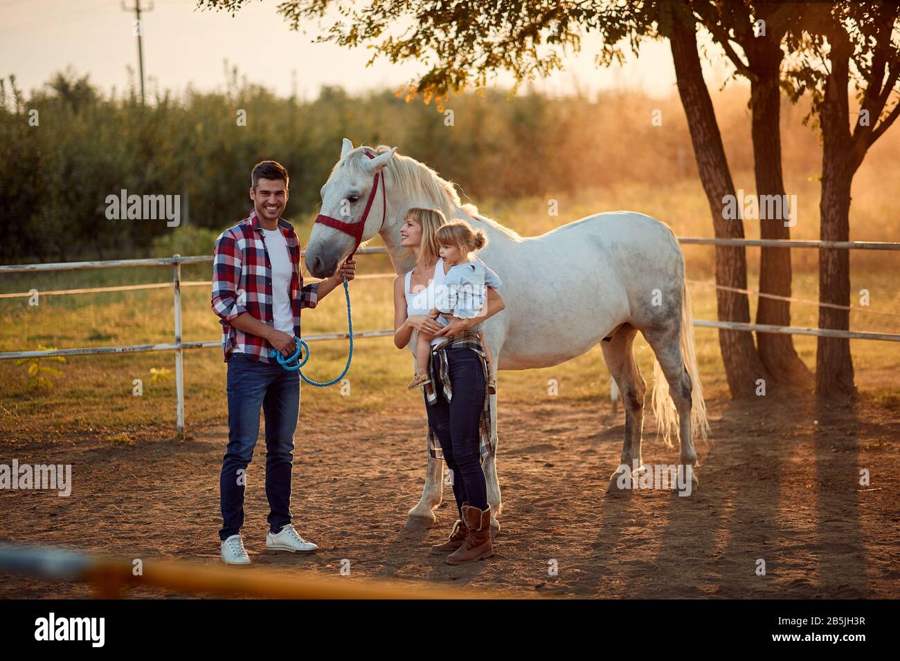 Smiling people enjoying on countryside at horse farm Stock Photo - Alamy