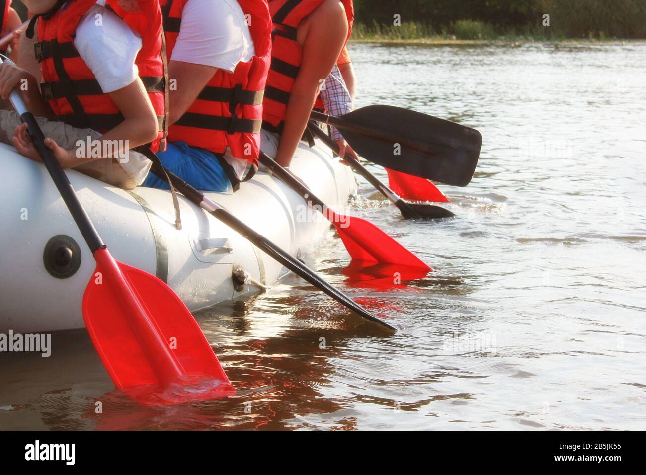 Rafting team , summer extreme water sport. Group of people in a rafting