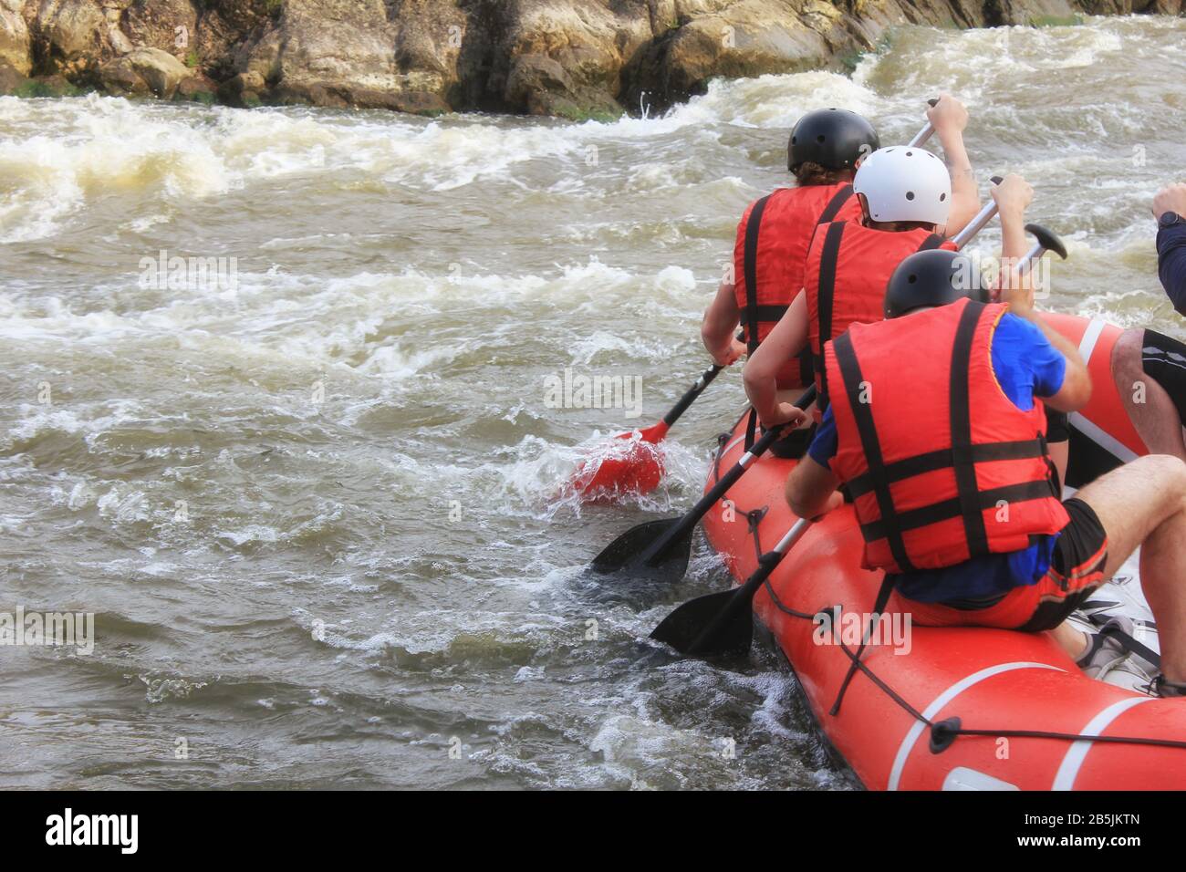 Rafting team , summer extreme water sport. Group of people in a rafting