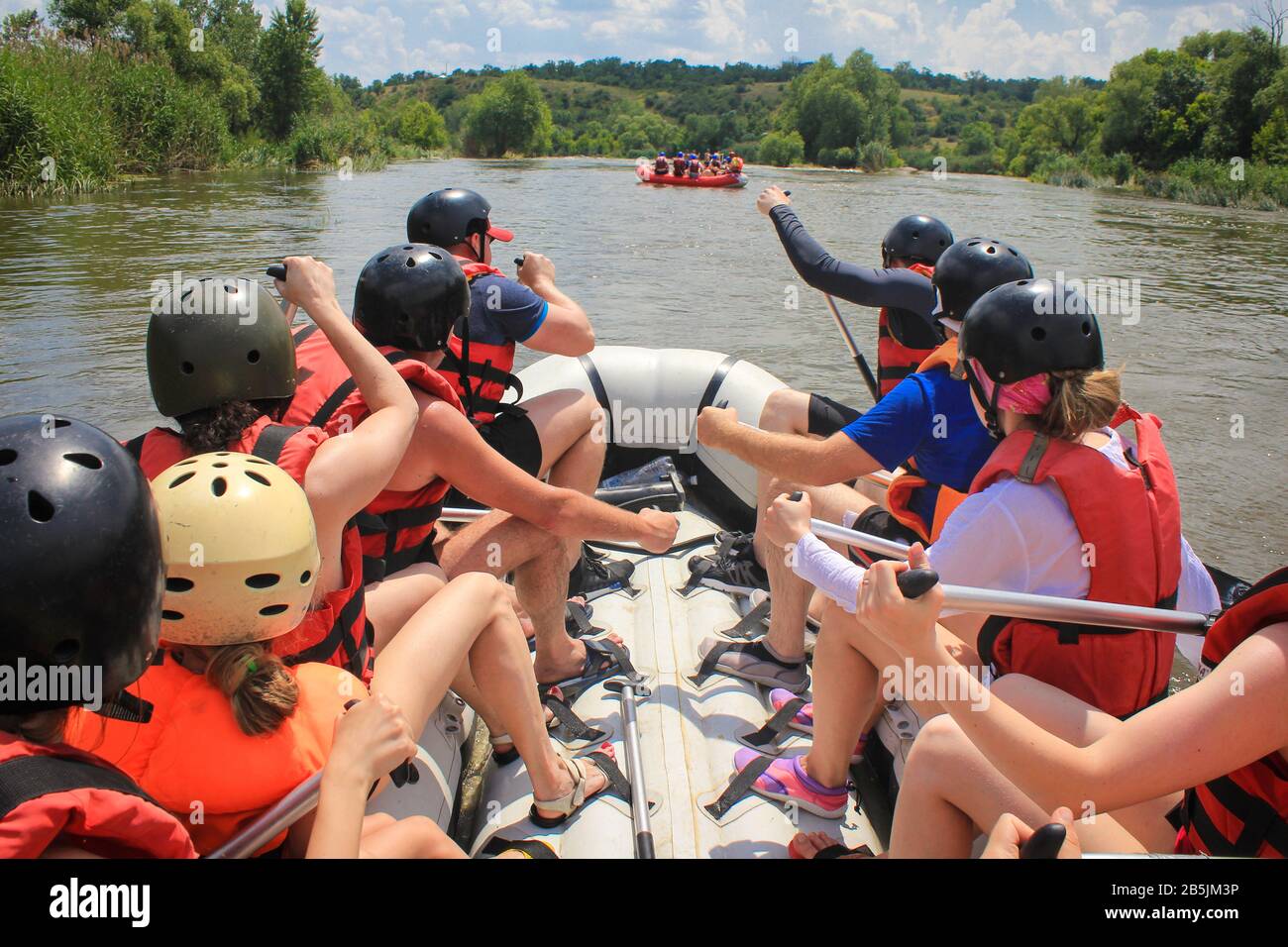 Rafting team , summer extreme water sport. Group of people in a rafting