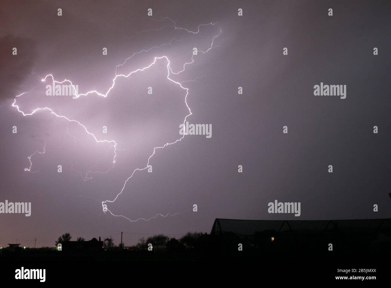 Lightning bolt in Transylvania crawls through the sky, creating a spooky atmosphere Stock Photo