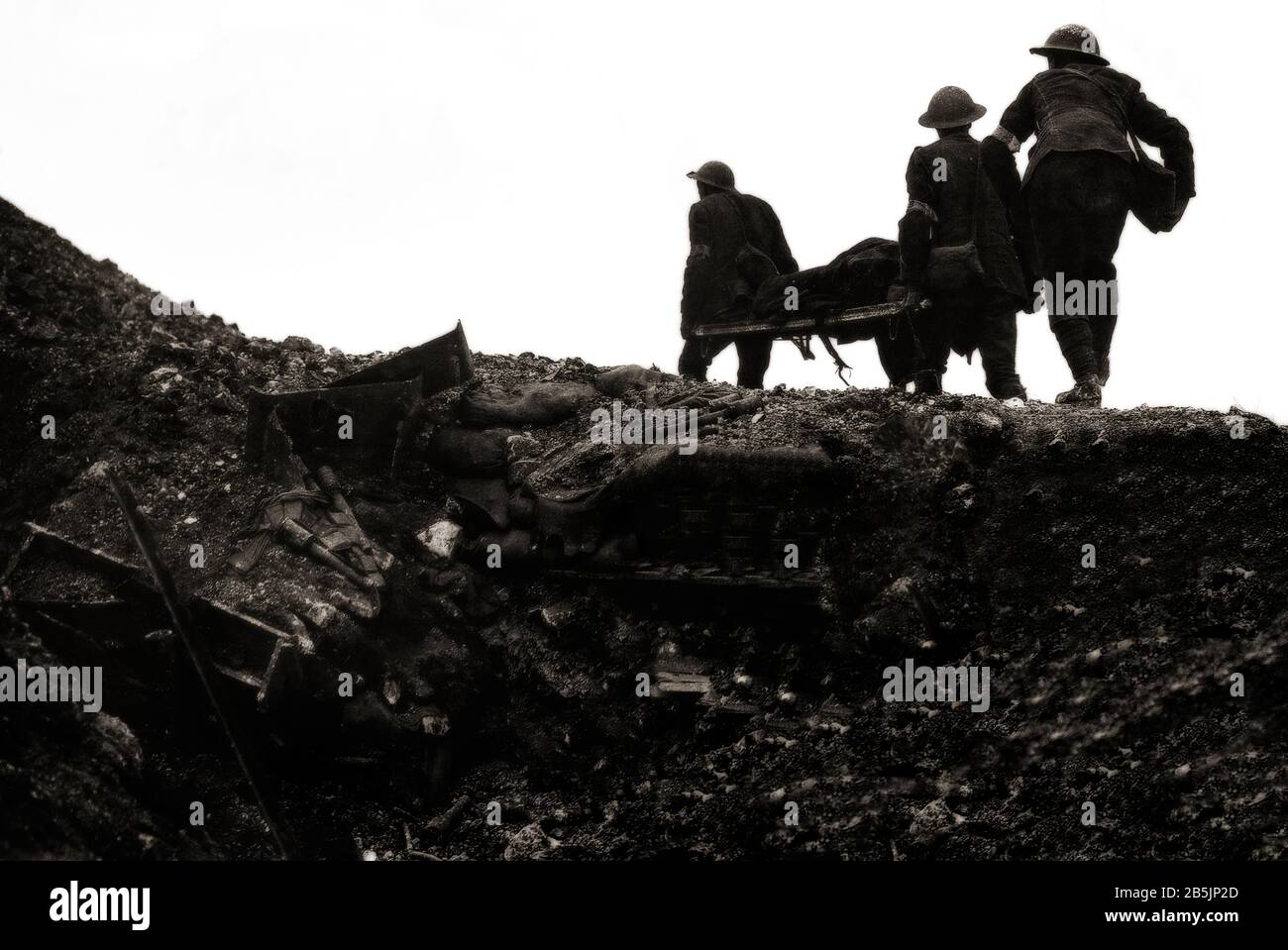British stretcher bearers carrying a wounded soldier over the top of a trench in the village of Thiepval Wood during the Battle of the Somme in August 1916. Stock Photo