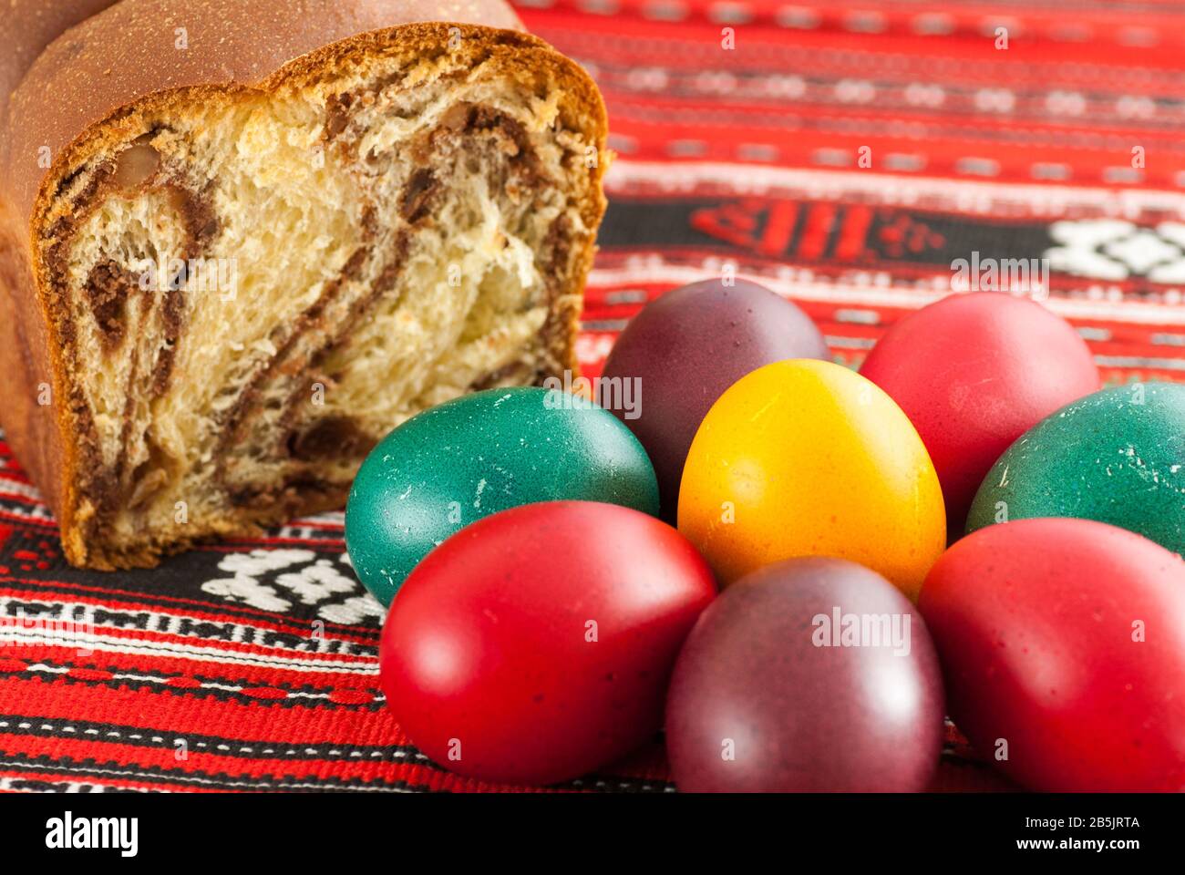 traditional orthodox sponge cake and colored easter eggs Stock Photo
