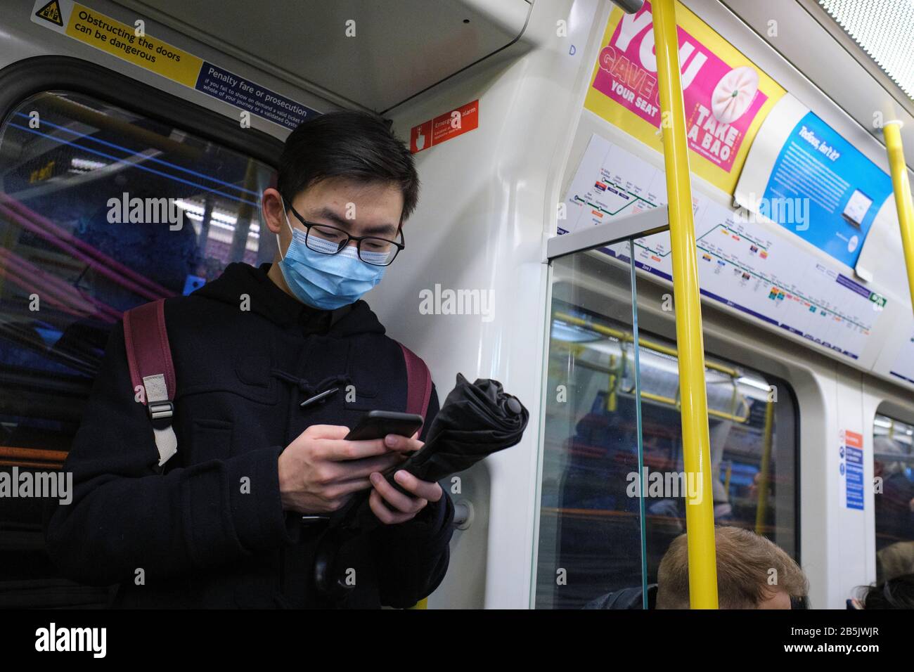Commuters on the London Underground wearing face masks to protect