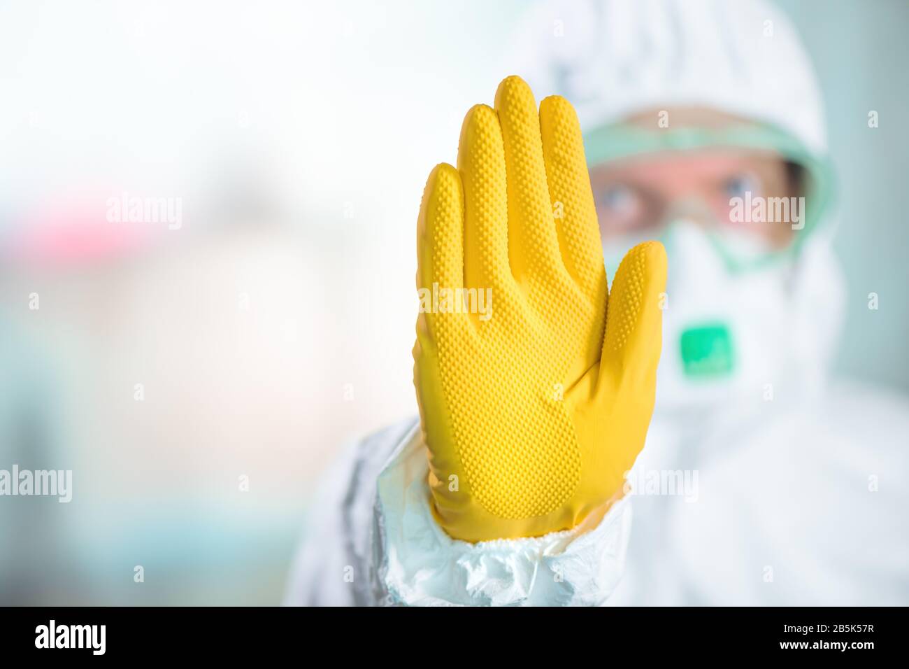 Female epidemiologist gesturing stop sign in hospital quarantine, selective focus Stock Photo