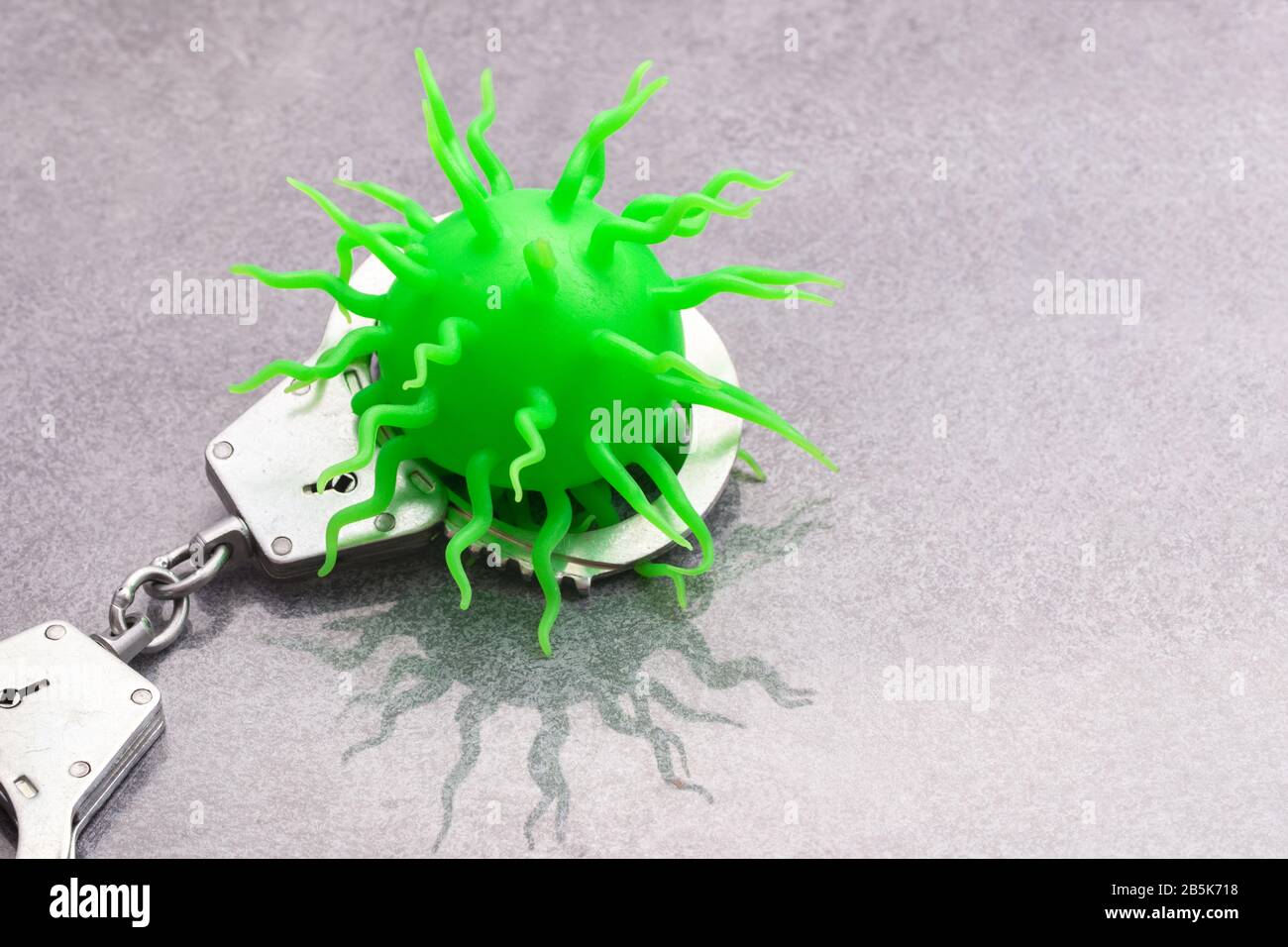 Covid in handcuffs Stock Photo