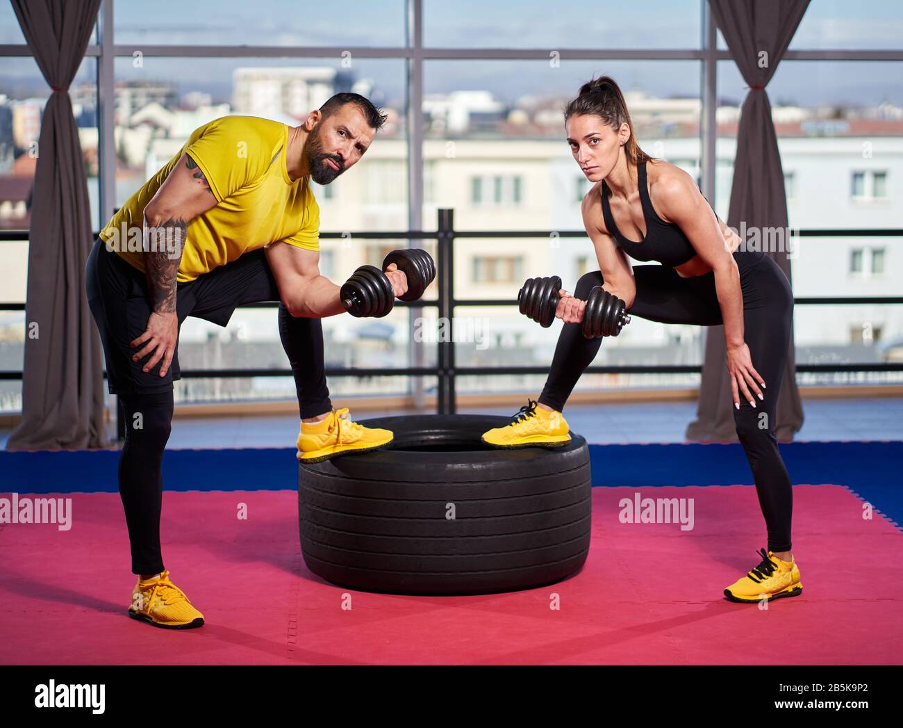 Fit couple doing workout together in the gym Stock Photo - Alamy