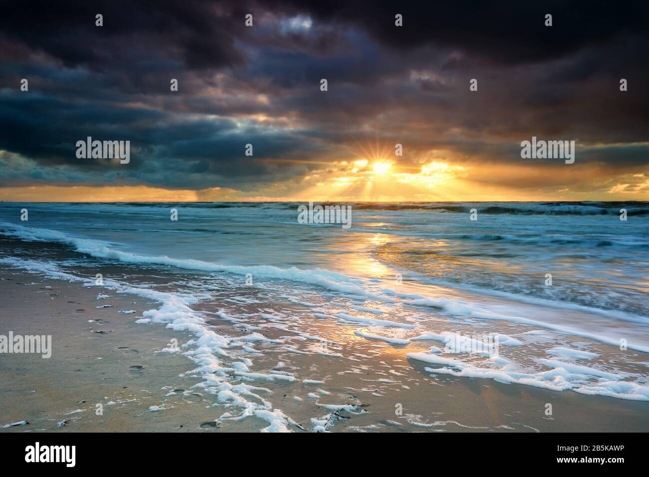 dramatic sunset over North sea waves Stock Photo