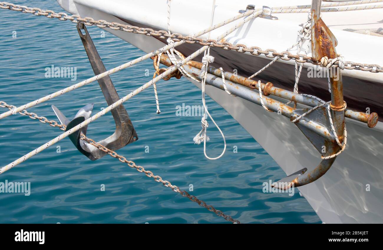 Anchor tied to the side of a moored ship boat Stock Photo