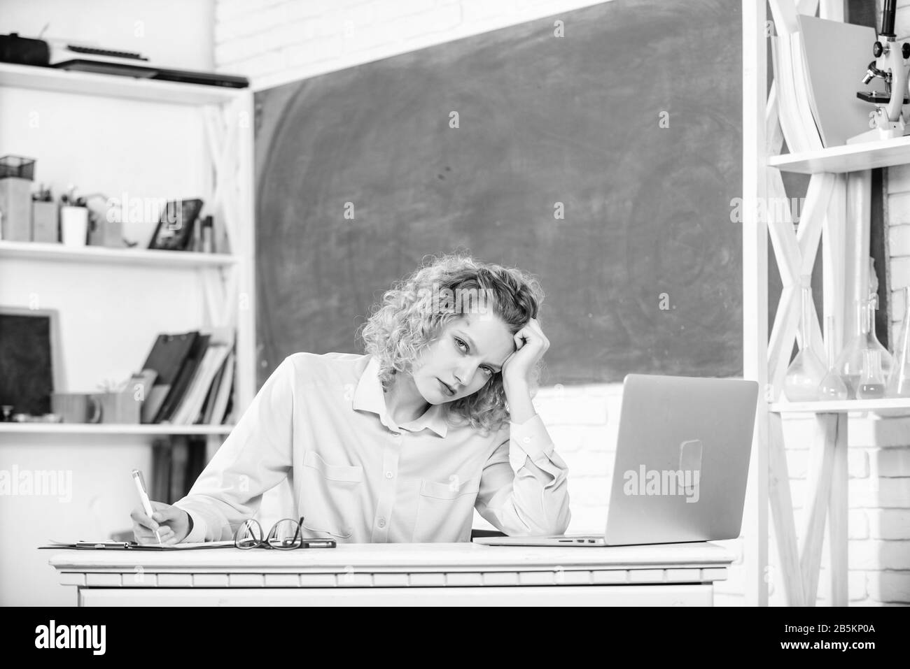 Exhausting lesson. Woman tired in school classroom. Teacher exhausted