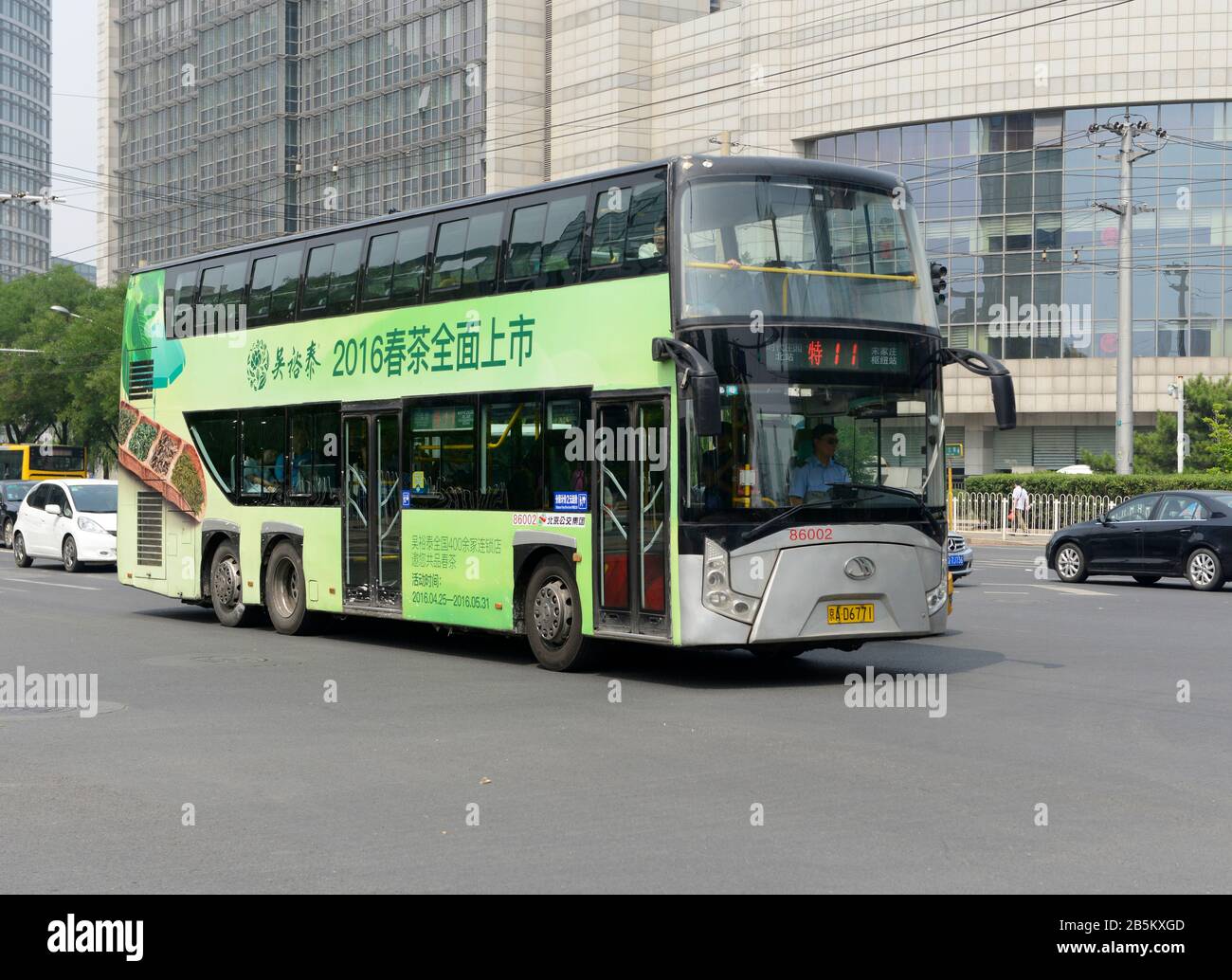 A double-decker bus on a main street in the Asian Games Villages