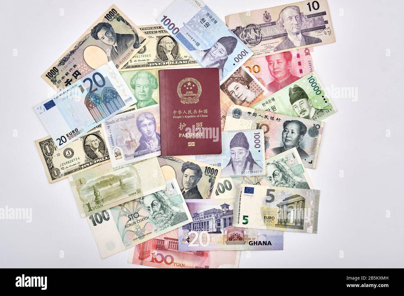 East meets west world travel concept with Chinese passport, and mixture of western and asian currencies Stock Photo