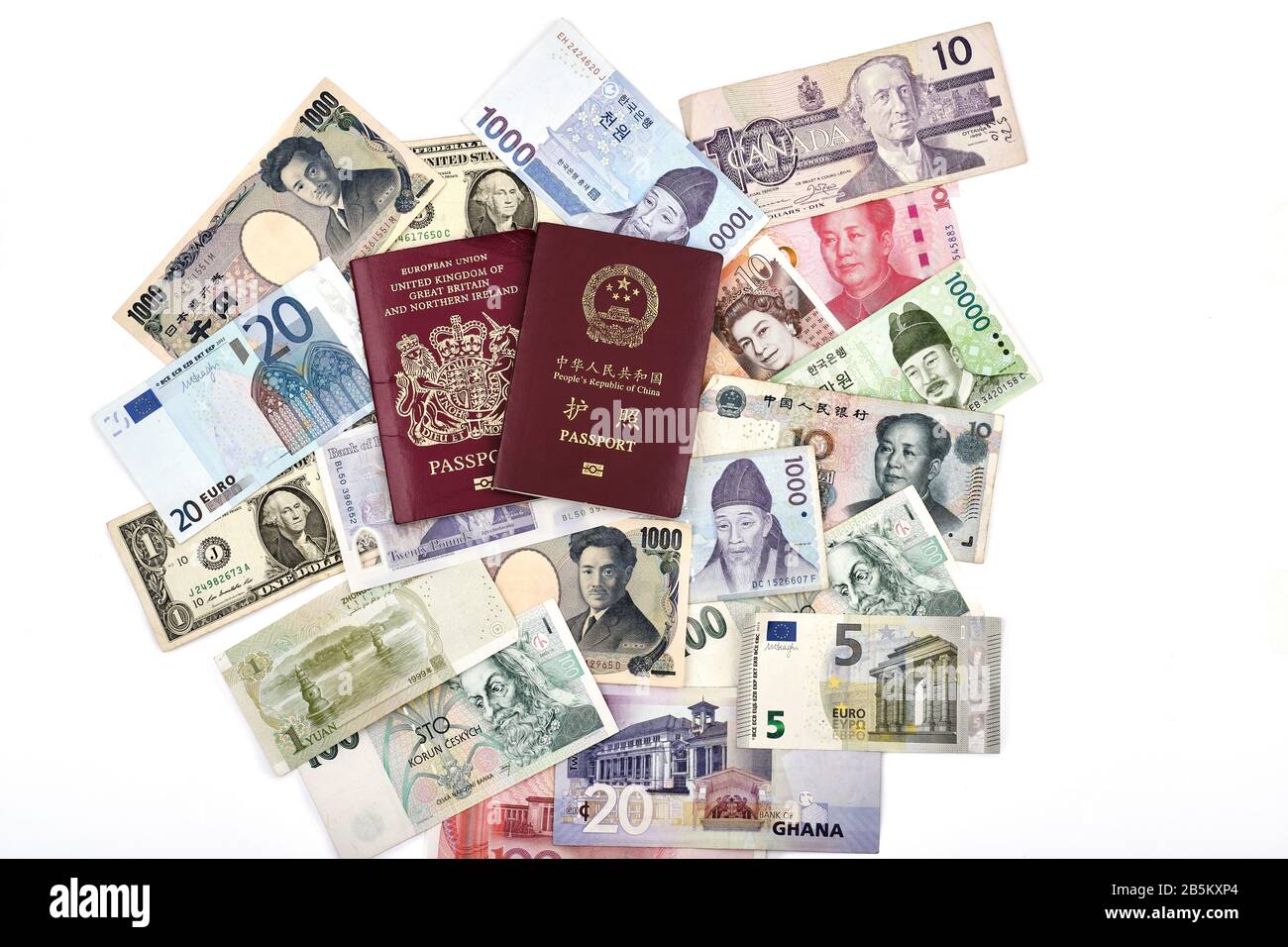 East meets west world travel concept with British European Union and Chinese passports, and mixture of western and asian currencies Stock Photo